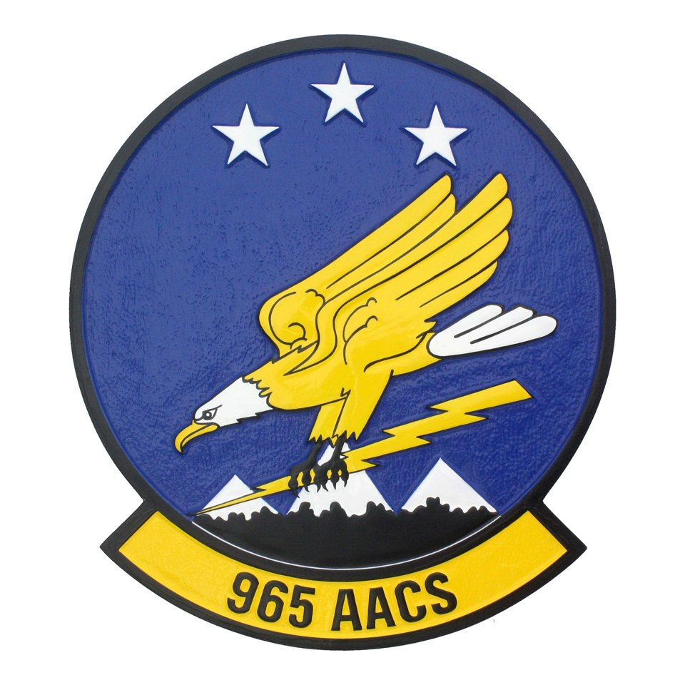 965th Airborne Air Control Squadron plaque with a yellow eagle, white stars and mountain detail.