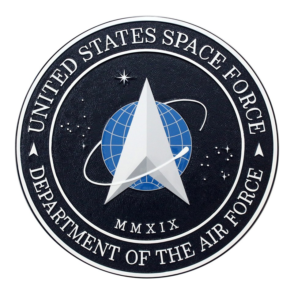 Round United States Space Force seal plaque with a silver delta, blue globe and white lettering on a black field.