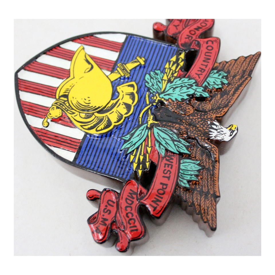 Angled view of a West Point crest plaque with an eagle, helmet and red scrollwork.